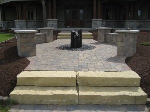 Front entry with limestone steps, sitting area and water feature
